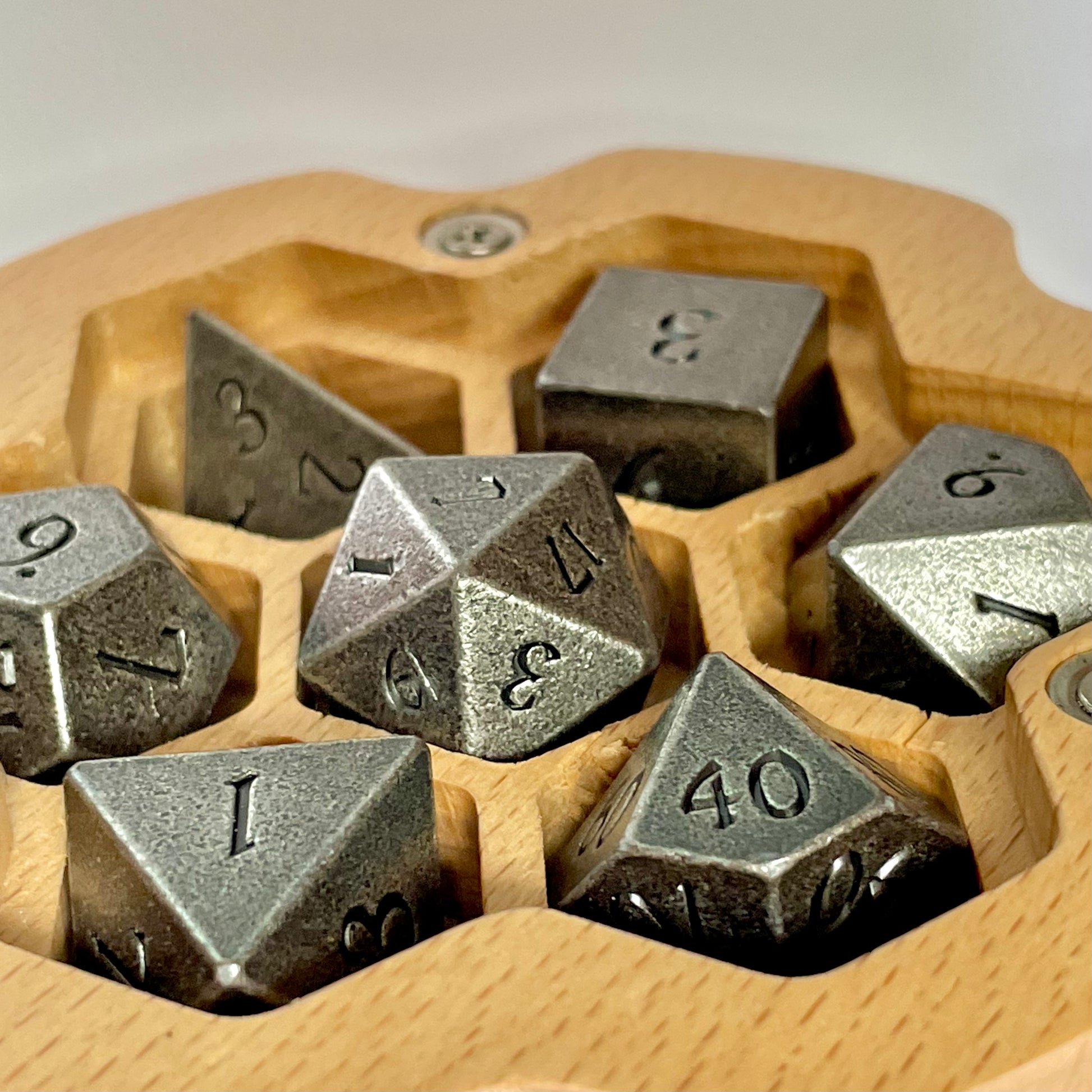 Wooden oak dnd dragon dice case open close up with metal dice inside